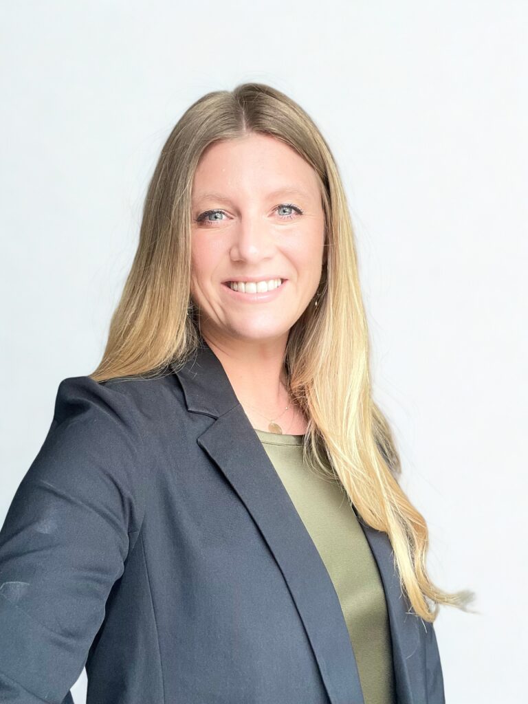 Professional headshot of Varina Winder smiling in a black blazer.